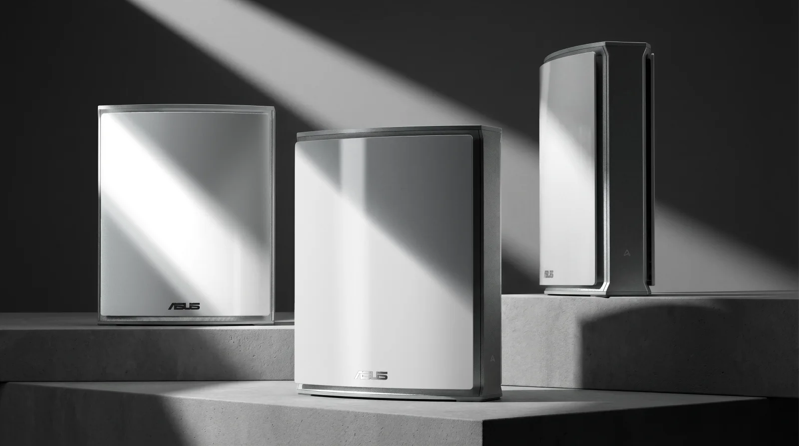 Three ASUS ZenWiFi BN12 Wi-Fi 8 mesh units on concrete pedestals in an official ASUS product photo